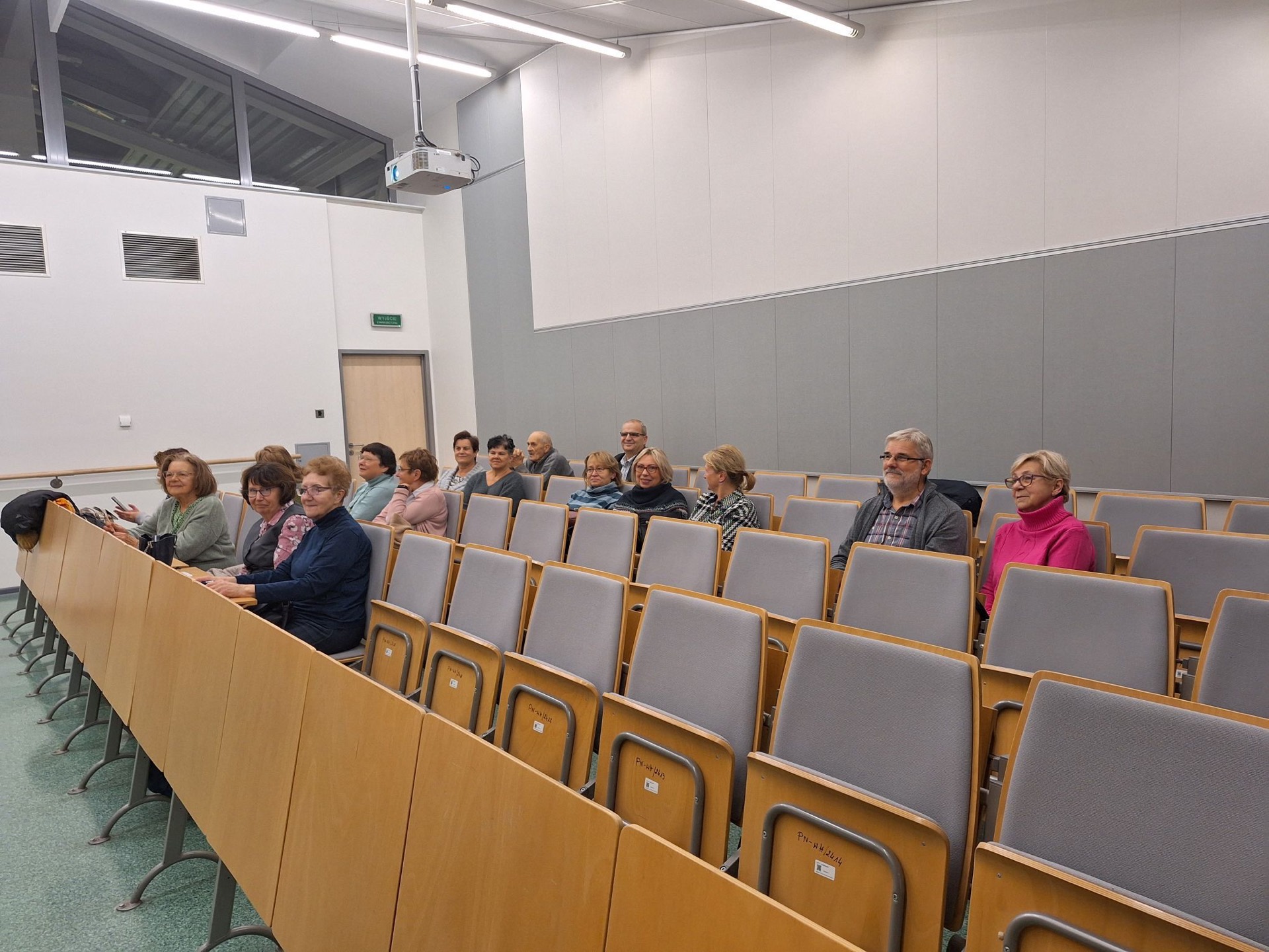 Zdjęcie przedstawia siedzących słuchaczy wykładu.